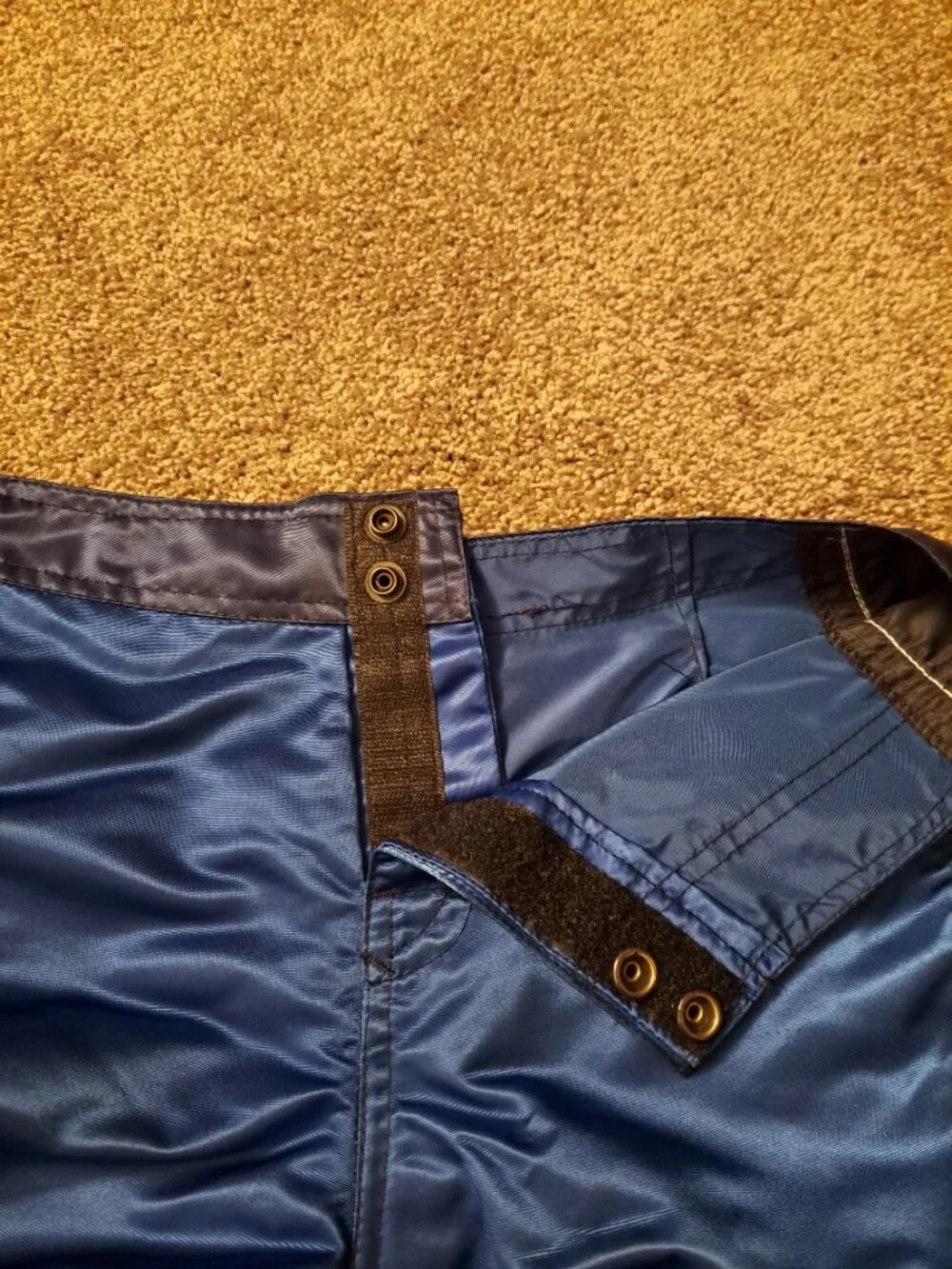 Vintage Fox Racing board shorts featuring a blue satin finish &white piping.
